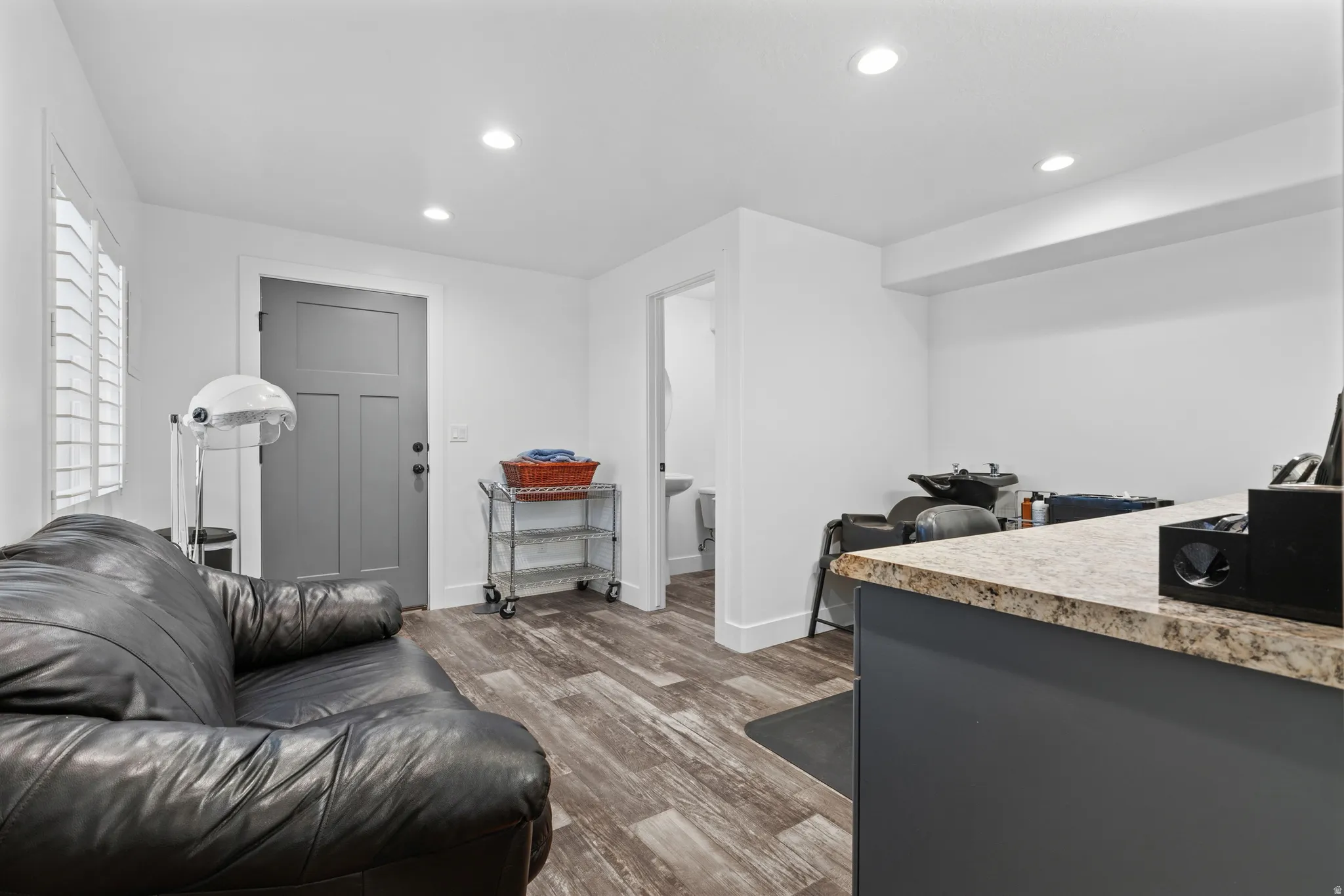 Interior space featuring wood-finish flooring, white walls, and recessed lighting