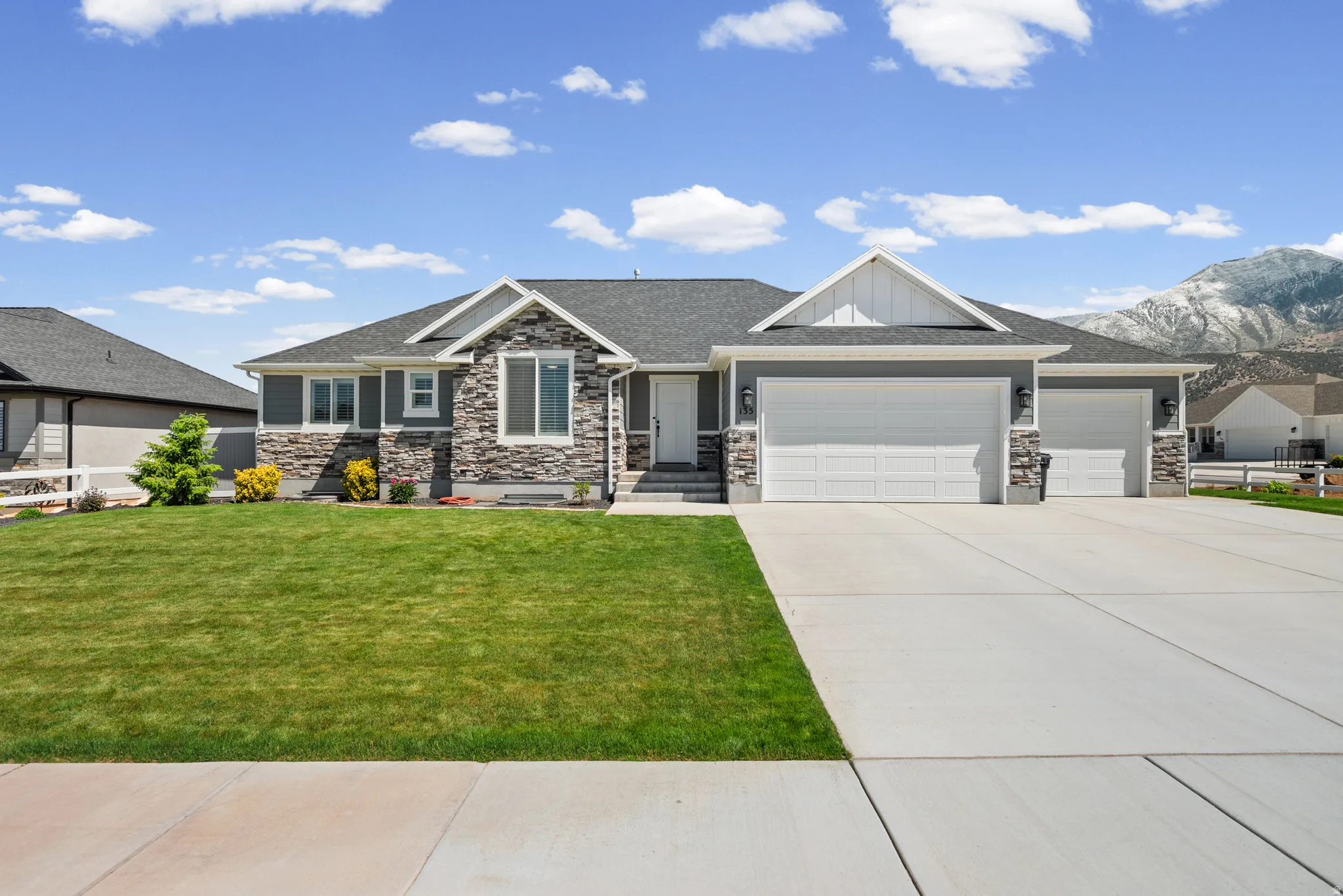 Ranch-style residence featuring a combination of stone veneer and horizontal siding