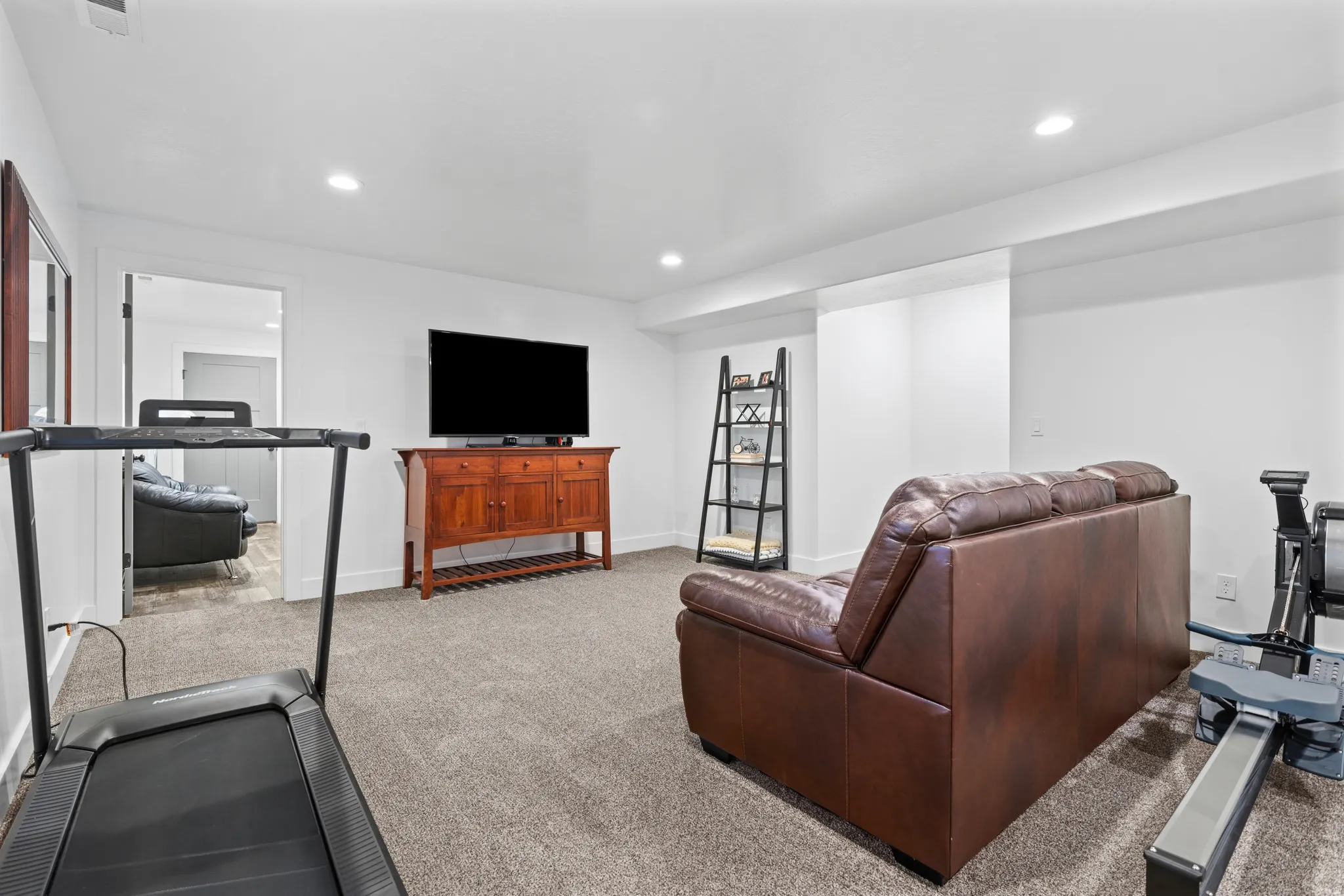 Carpeted recreation room featuring recessed lighting and a white trim package