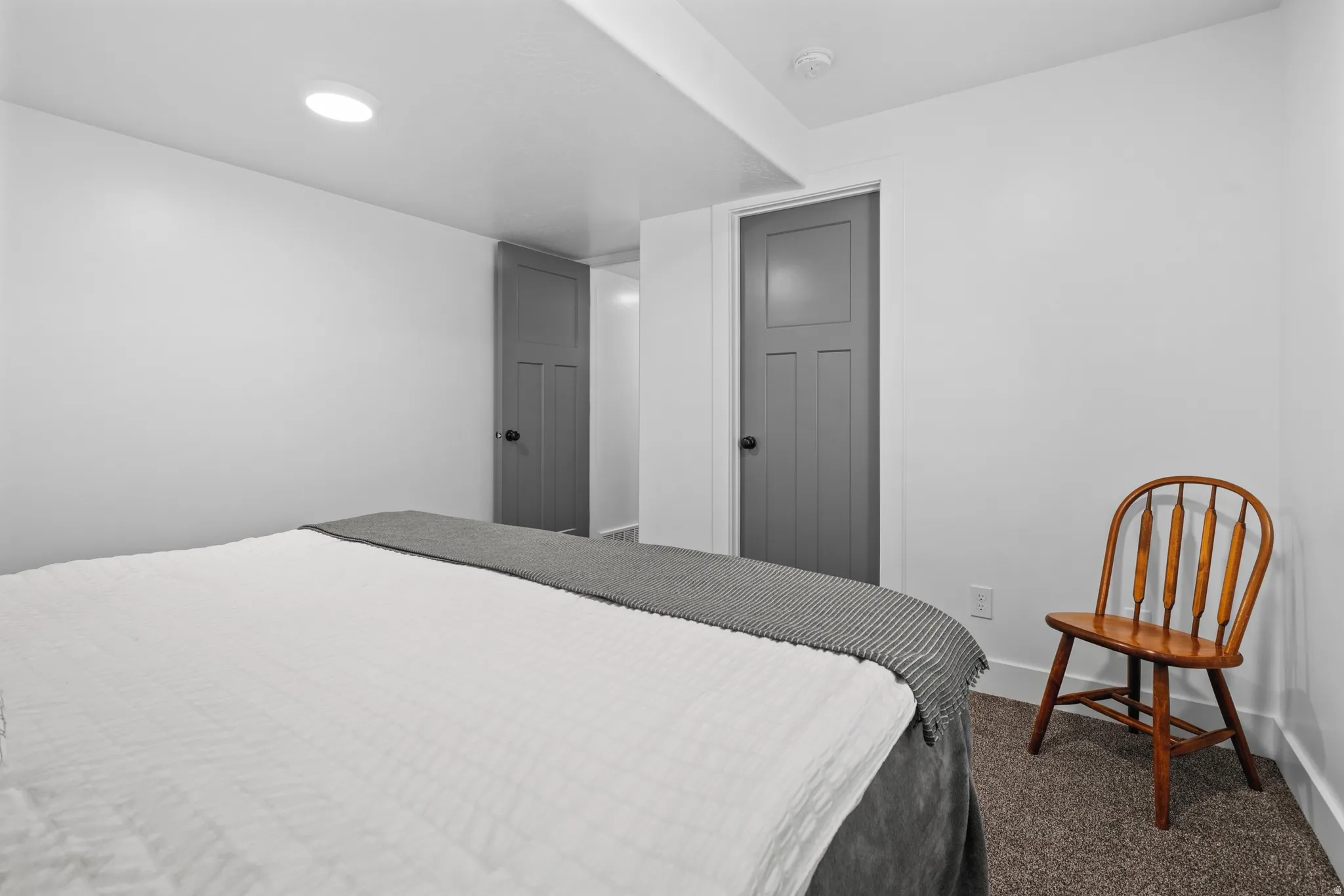 Interior space featuring white walls, recessed lighting, and panel doors with dark hardware
