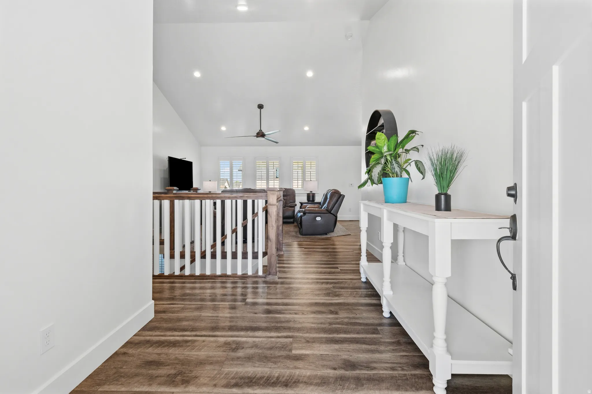 Entryway with wood-finish flooring, crisp white walls, and a recessed lighting