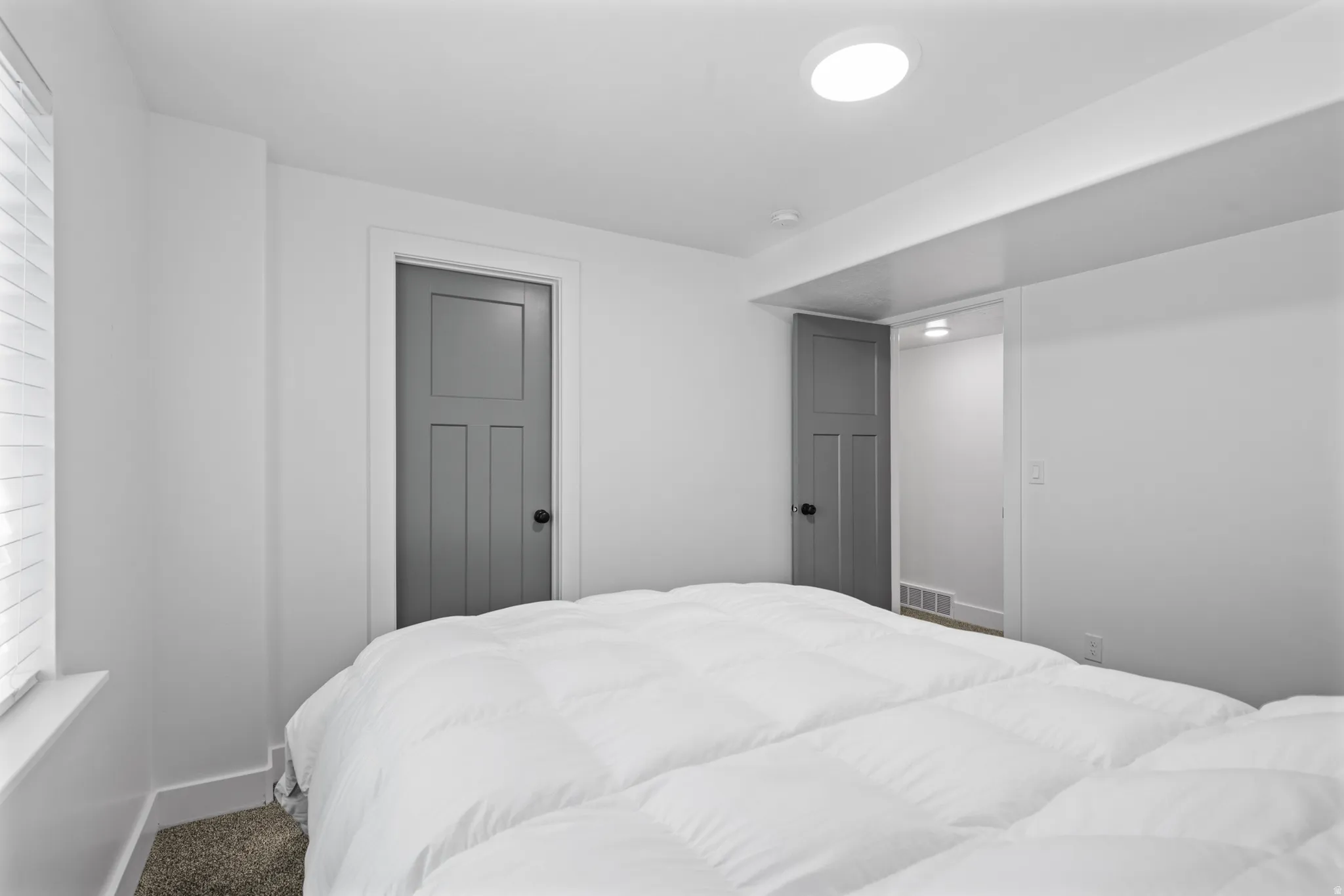 Bedroom featuring neutral-toned carpet flooring and white walls