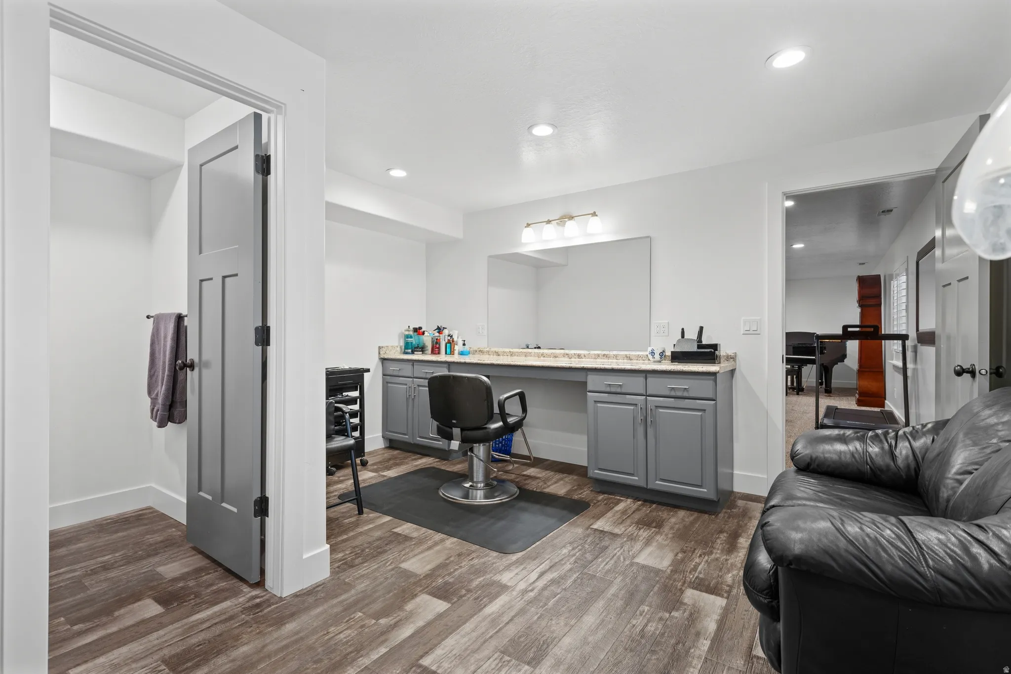 Spacious room featuring wood-finish flooring, recessed lighting, and a neutral color palette