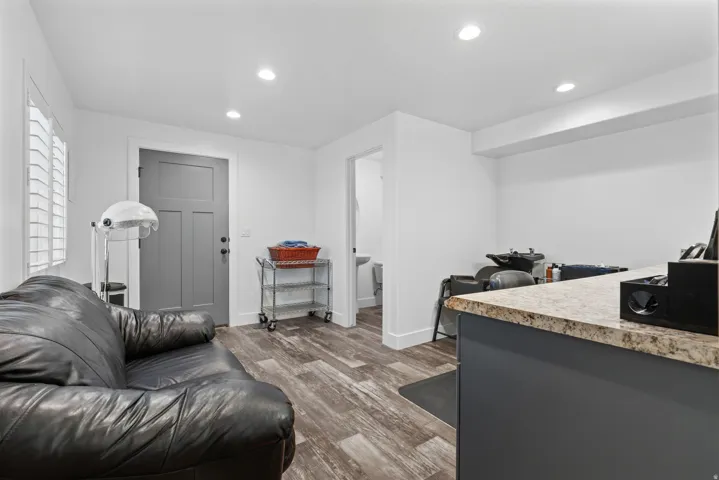 Interior space featuring wood-finish flooring, white walls, and recessed lighting