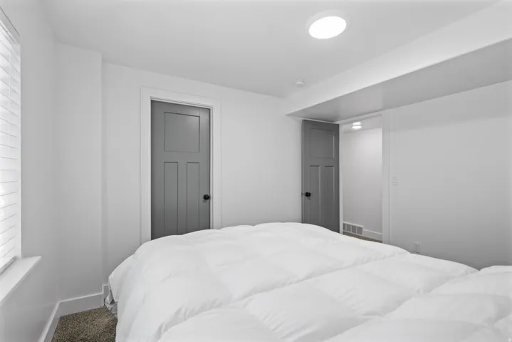 Bedroom featuring neutral-toned carpet flooring and white walls