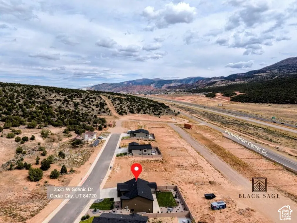 New construction property featuring a dark-toned roof and a paved driveway