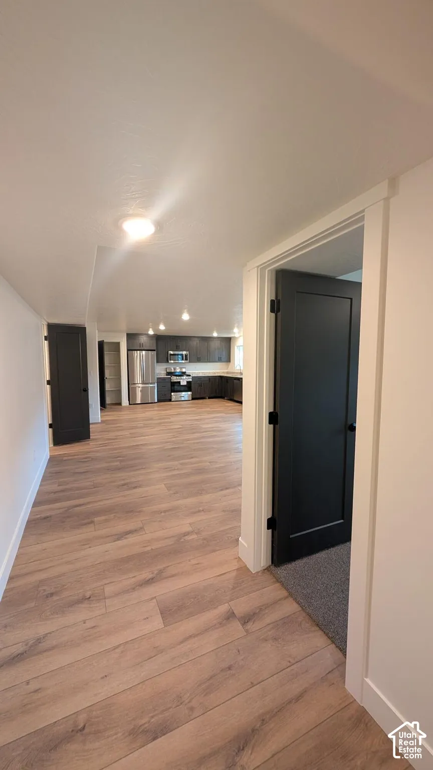 Wood-finish flooring throughout, complemented by dark interior doors with matte black hardware