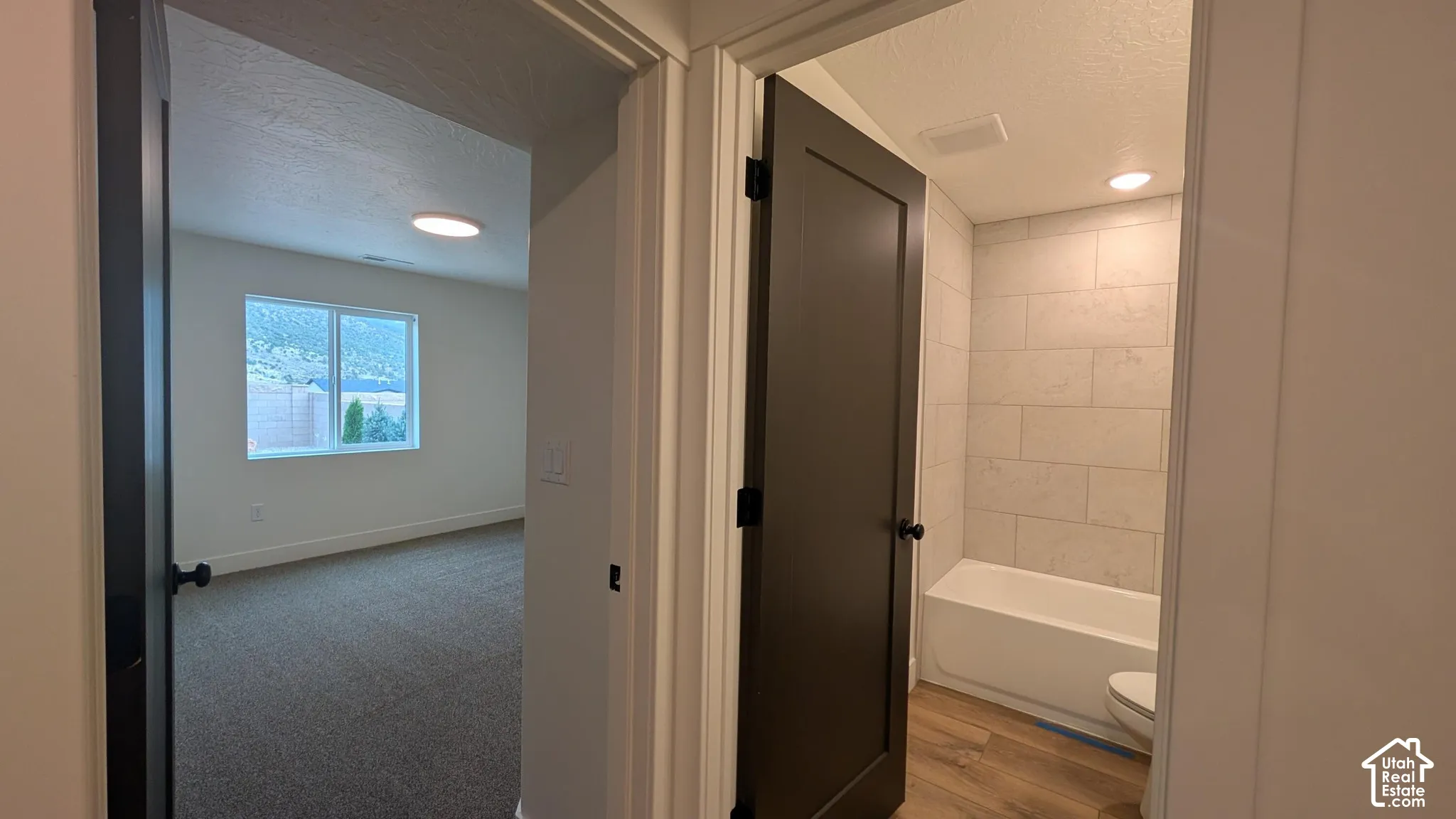 Bedroom featuring a large window, recessed lighting, and carpet flooring