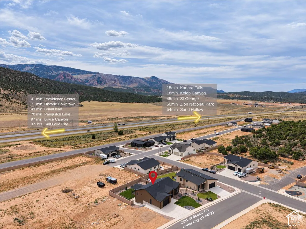 Aerial perspective of a developed residential community with desert landscaping and mountain scenery
