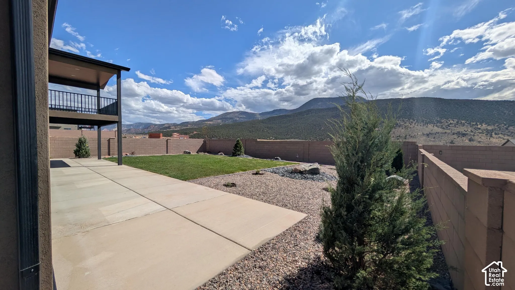 Outdoor patio with concrete slab and gravel landscaping