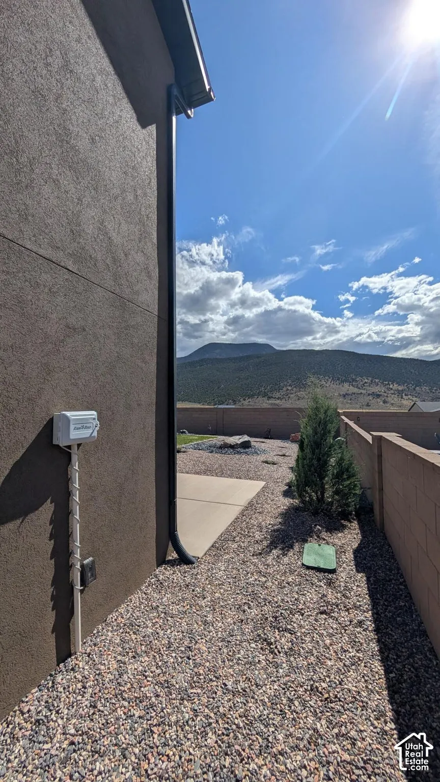 Low-maintenance landscaping featuring decorative gravel, a concrete pathway, and a block wall perimeter