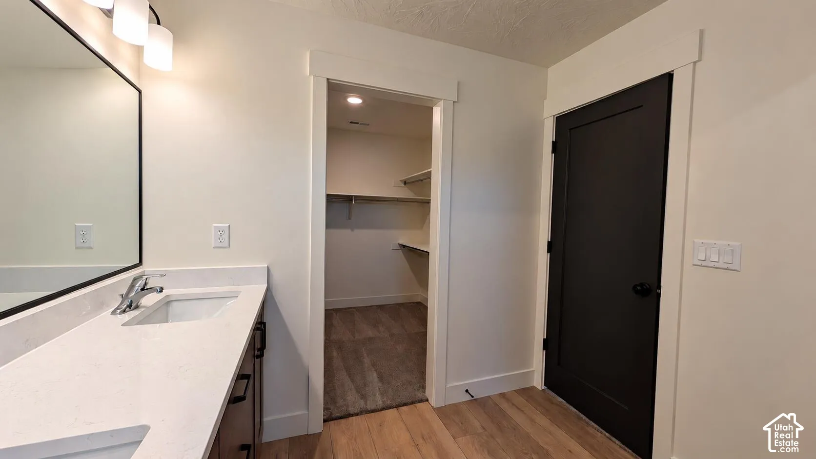 Single vanity with an integrated sink and light-colored countertop