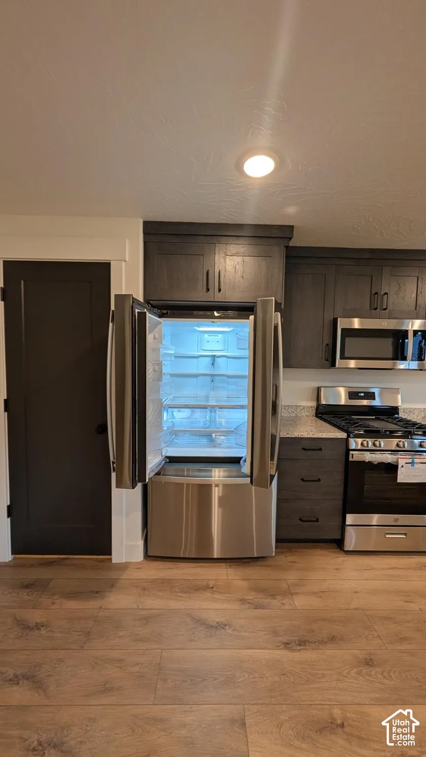 Wood-finish flooring complementing dark wood-tone cabinetry