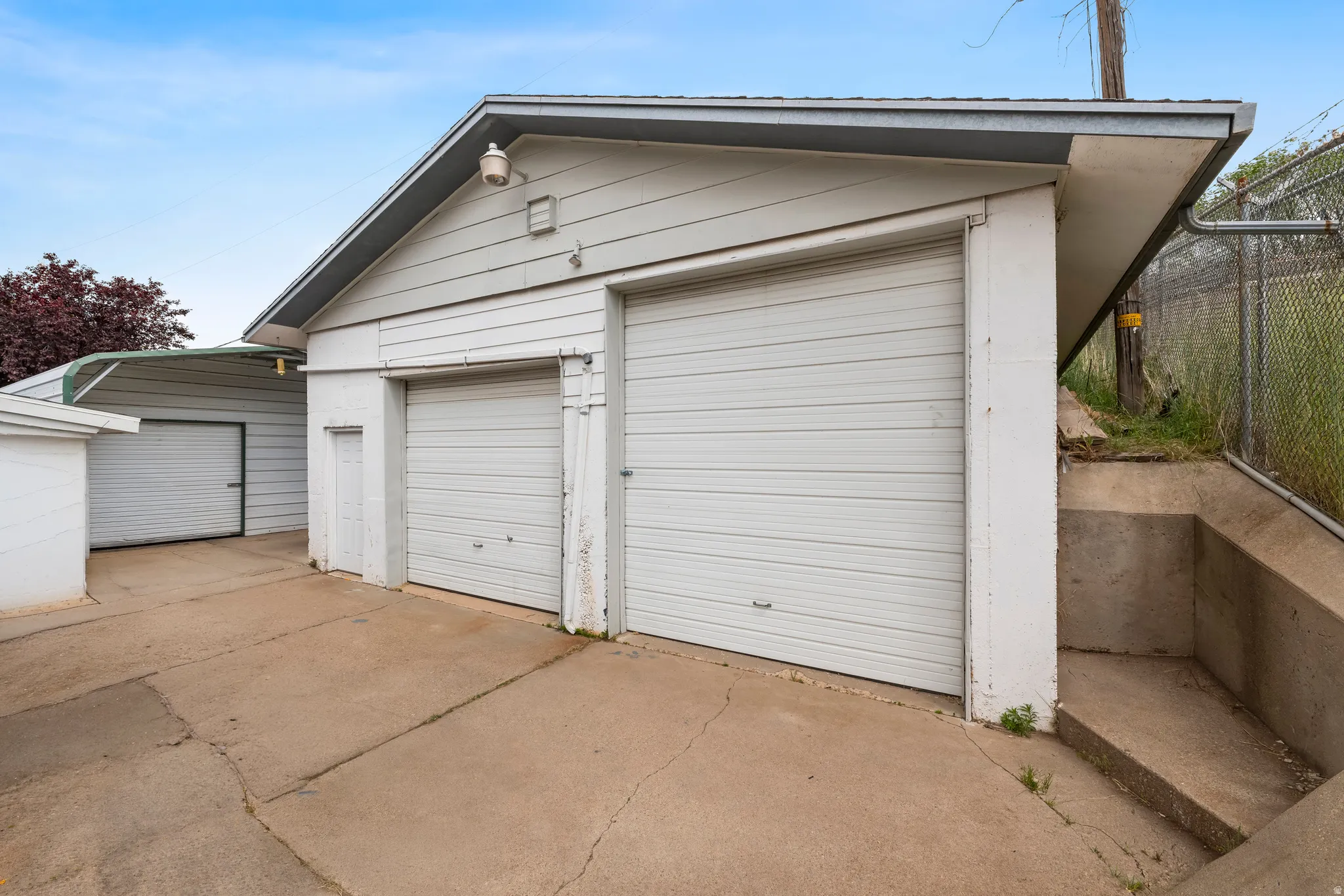 Two white garage doors with horizontal paneling