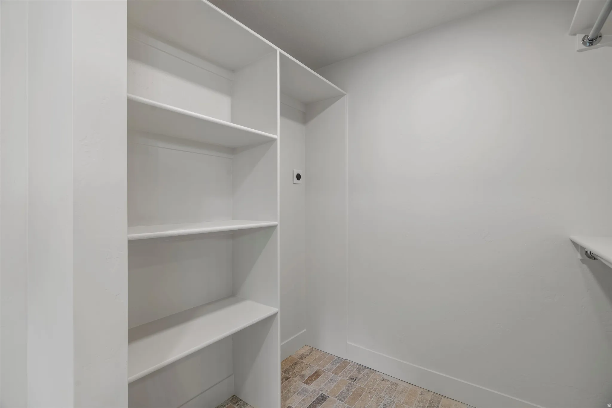 Laundry Room Built-in shelving system with white finishes, offering multiple storage levels