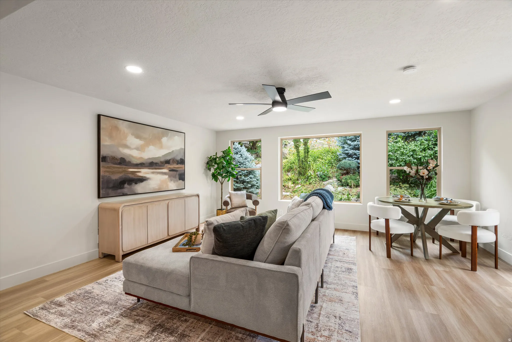 Expansive open-concept living space featuring light wood-finish flooring and recessed ceiling lighting