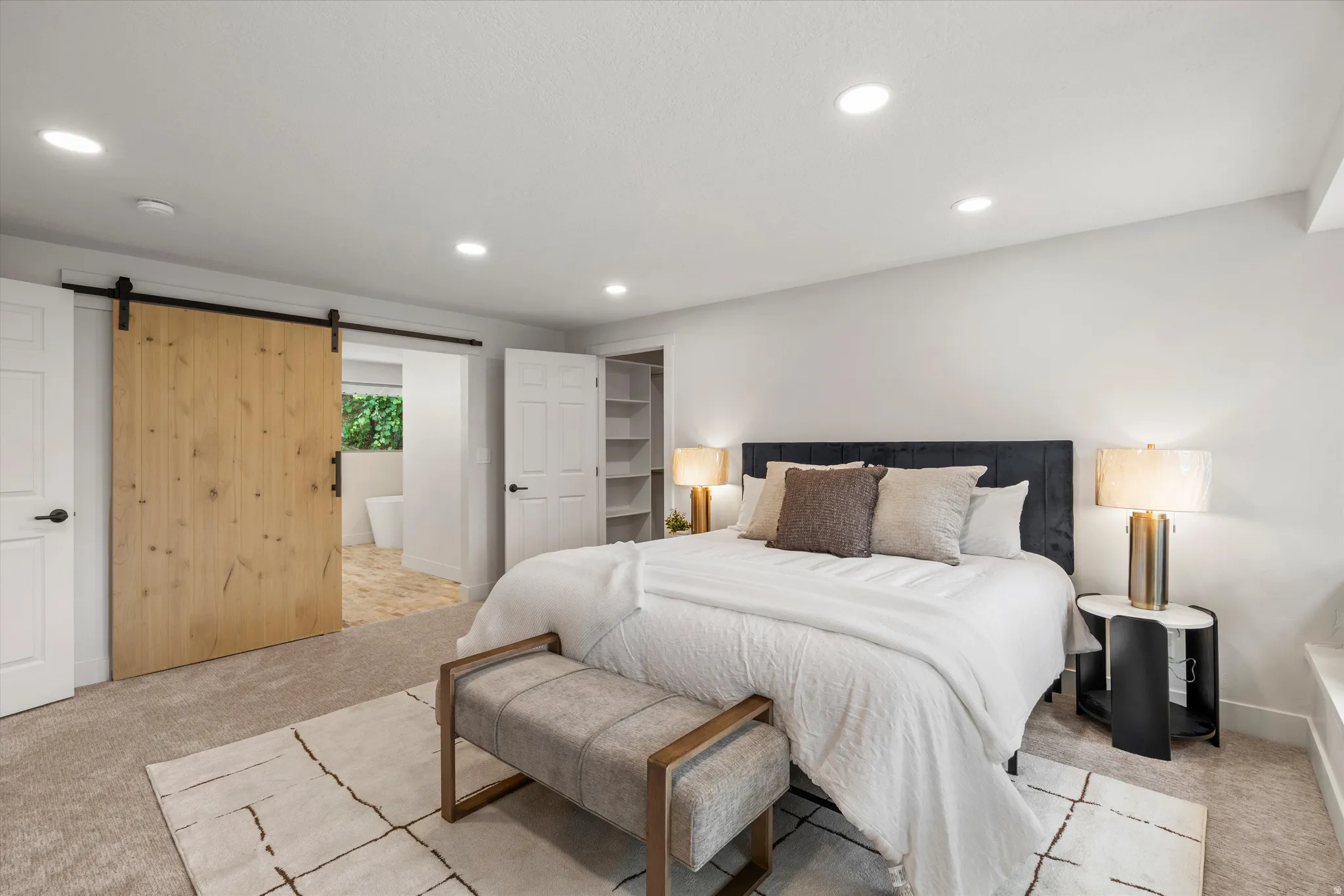 Spacious room featuring light-toned carpeting and recessed ceiling lighting