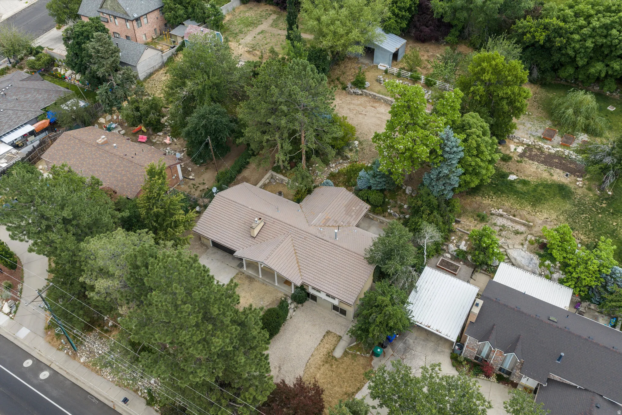 Single-story residence featuring a brown shingled roof, attached garage, and a covered front porch