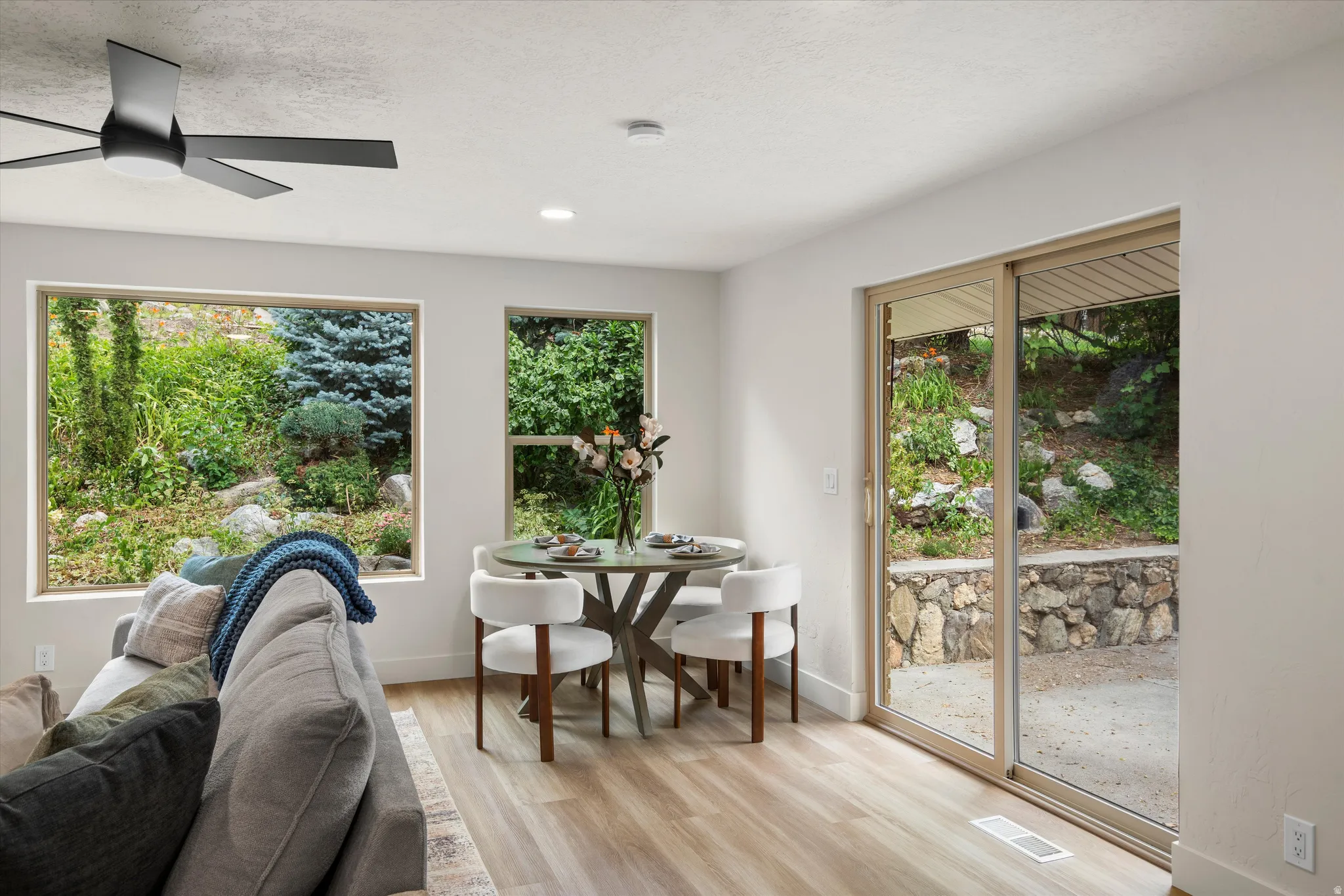 Interior space featuring light wood-finish flooring, recessed lighting, and a contemporary ceiling fan
