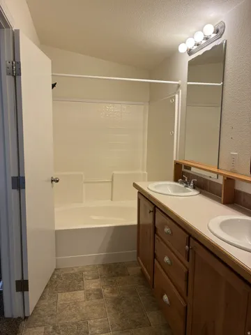Double vanity featuring integrated sinks and wood-finish cabinetry