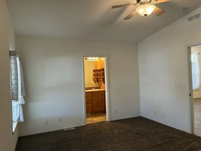 Primary bedroom with ceiling fan