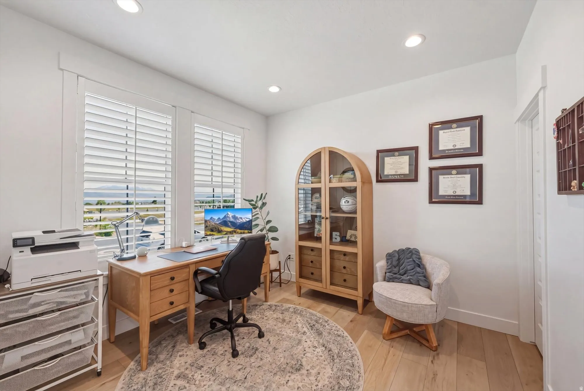 Well-lit room with recessed lighting and light wood-finish flooring