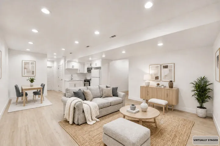 Virtually staged basement apartment.. Open-concept living space featuring wood-finish flooring and recessed lighting
