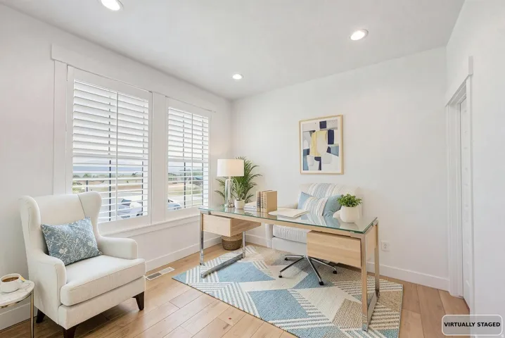Virtually staged, Bright interior space featuring wood-finish flooring and recessed lighting.