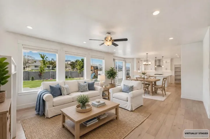 Virtually staged, Open-concept living area featuring light wood-finish flooring and recessed lighting.