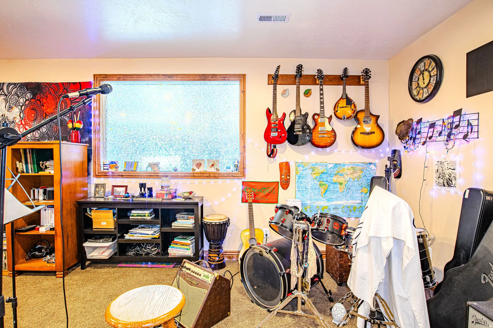 Spacious room featuring carpeting, a large window with wood trim, and light beige wall paint