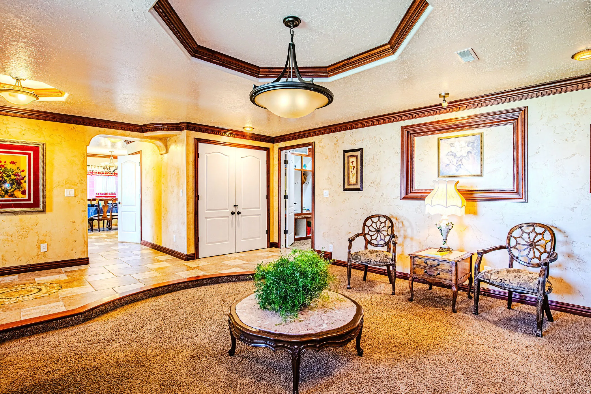 Entry area featuring a coffered ceiling with a central pendant light fixture and recessed lighting
