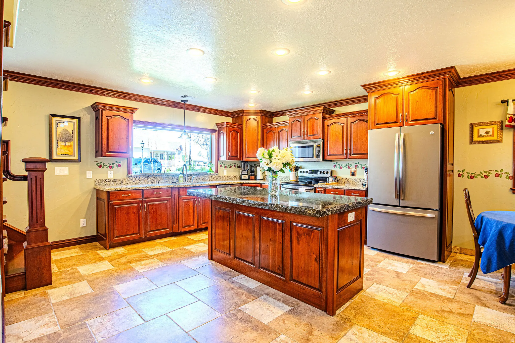 Kitchen featuring wood cabinetry, granite countertops, stainless steel appliances, a center island, and recessed lighting