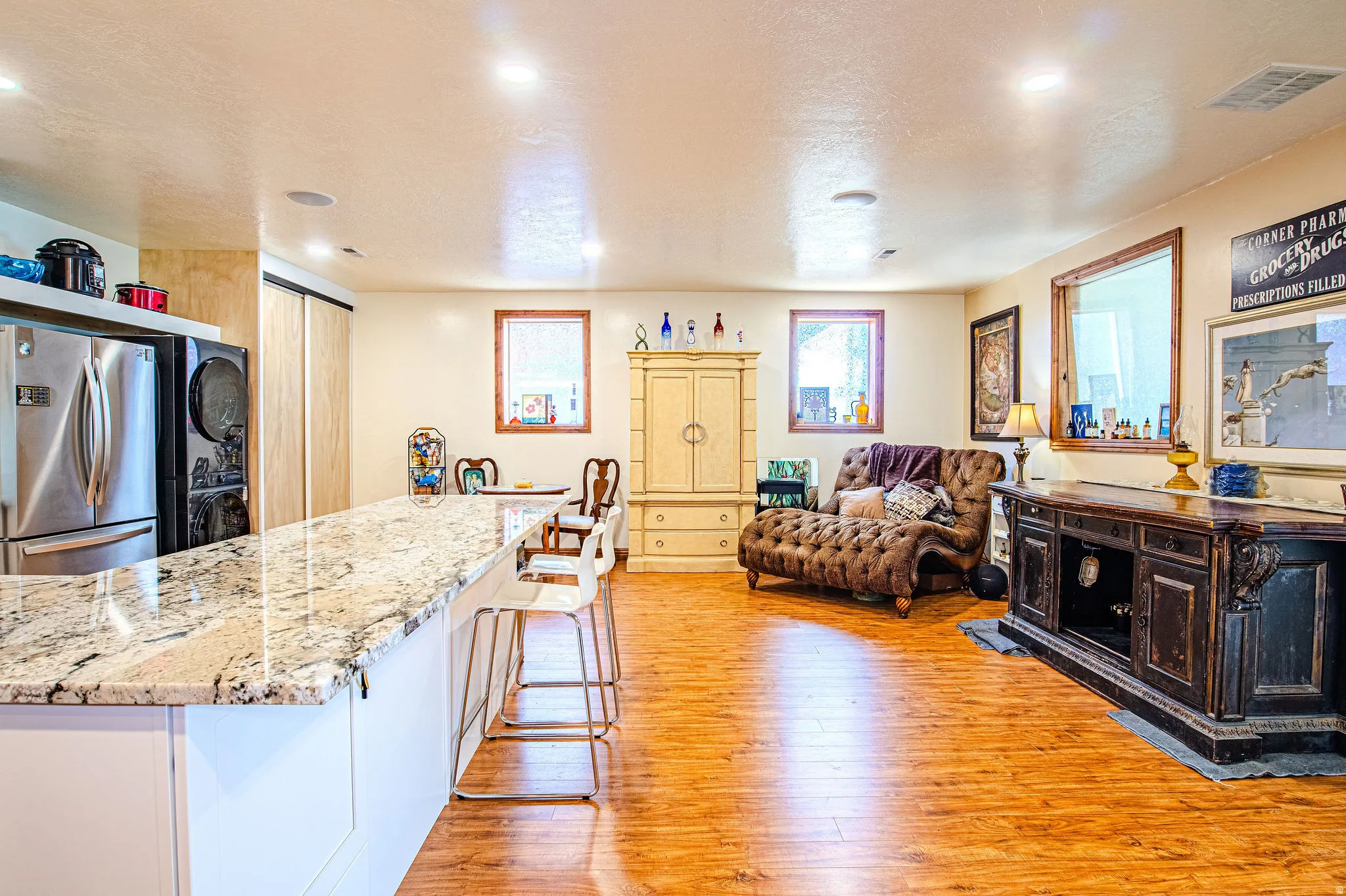 Spacious open-concept interior featuring light-toned walls and wood-finish flooring