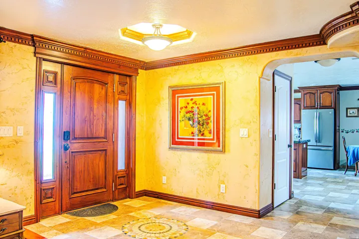 Custom wood entry door with vertical sidelights and decorative trim