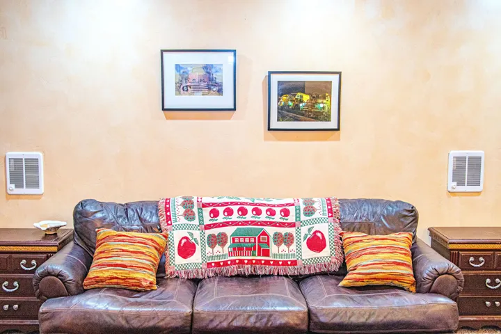Textured wall finish with two wall-mounted heating units.