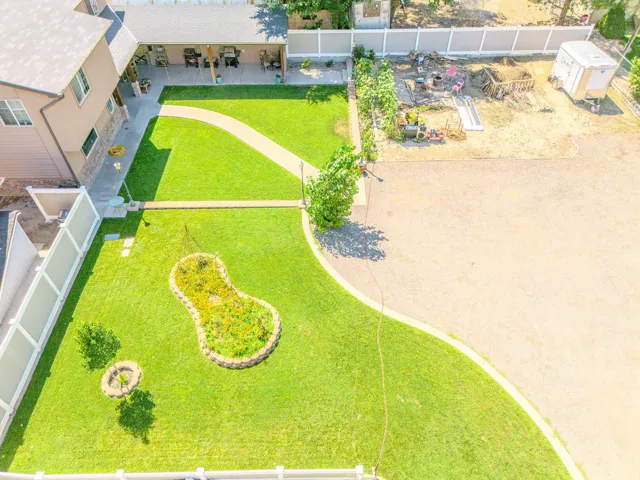 Expansive green lawn with a curved paved pathway