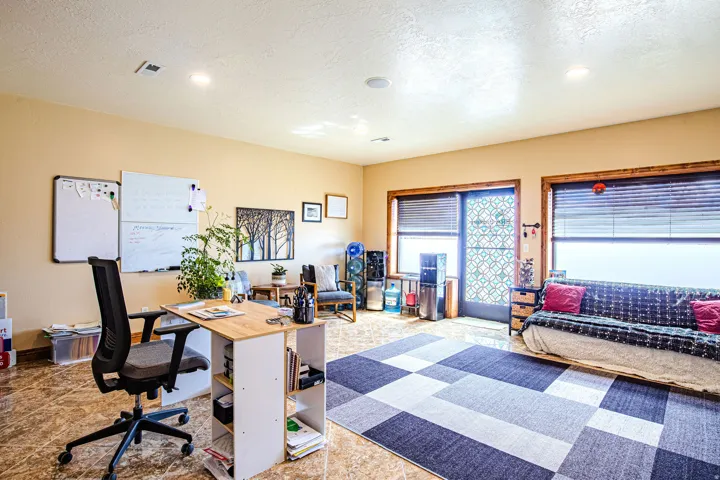 Spacious office with entrance to Main Street. featuring wood-finish flooring, recessed lighting, and large windows with blinds