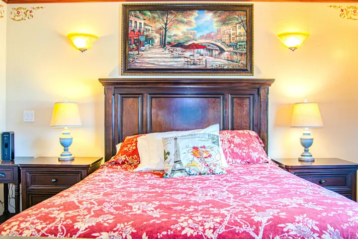 Hardwood headboard with carved details, flanked by two coordinating nightstands with drawer storage