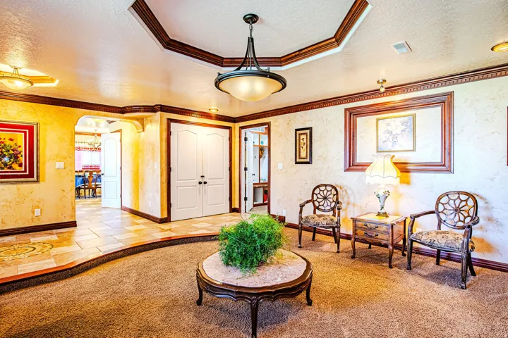 Entry area featuring a coffered ceiling with a central pendant light fixture and recessed lighting