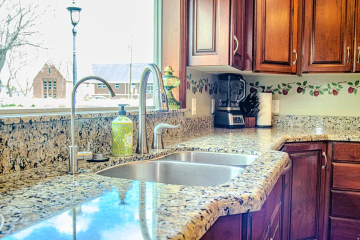 Kitchen featuring a double basin stainless steel sink with a gooseneck faucet
