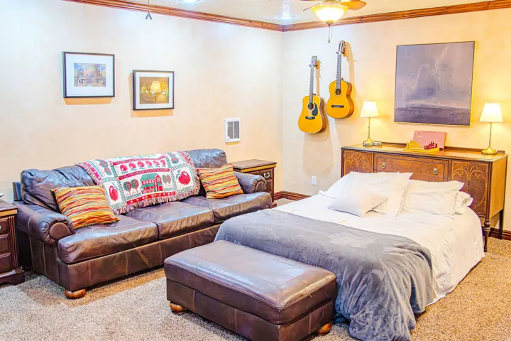 Carpeted family/game room with extra bed for additional guest sleeping area with a ceiling fan, wall-mounted heater, and recessed lighting