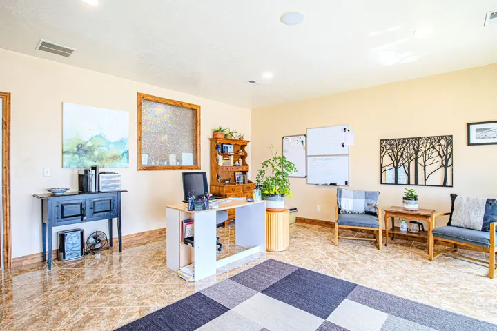 Spacious office featuring glossy tile flooring, recessed lighting, and a neutral wall palette