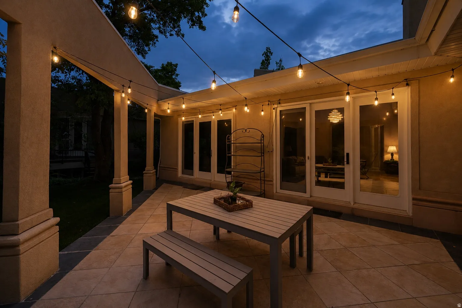 Expansive outdoor patio featuring string lighting and a tiled surface