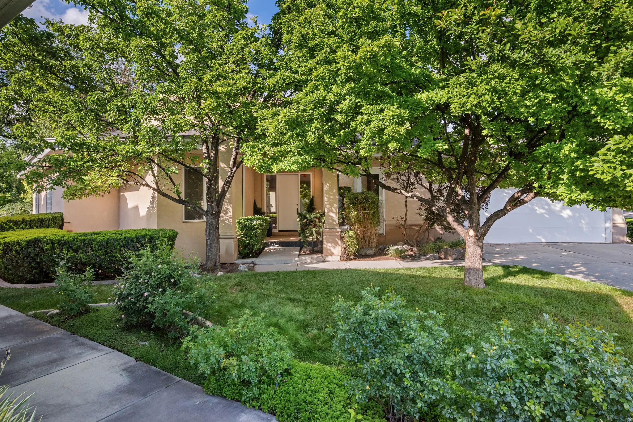 Stucco exterior with a covered entry and dual front doors