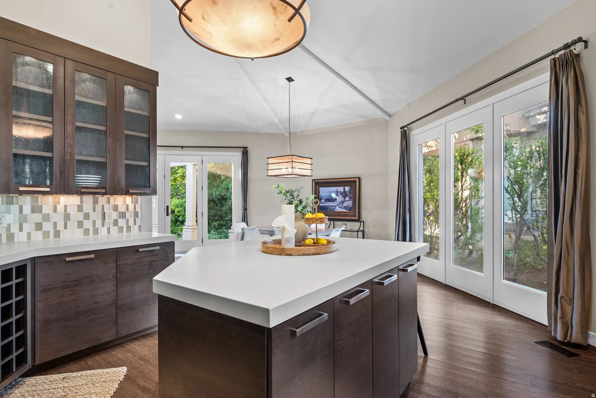 Kitchen island featuring a light-toned countertop and integrated cabinetry