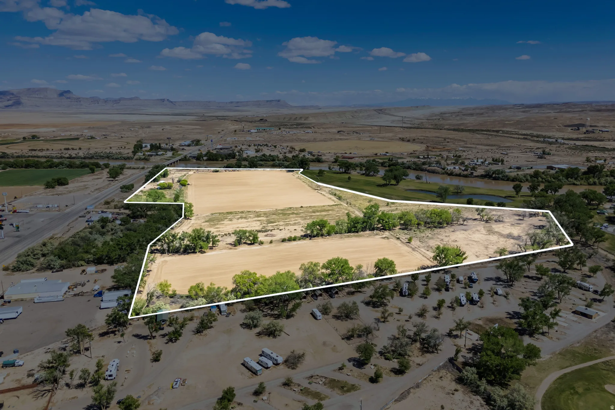 Expansive parcel featuring open land, mature trees, and proximity to a river