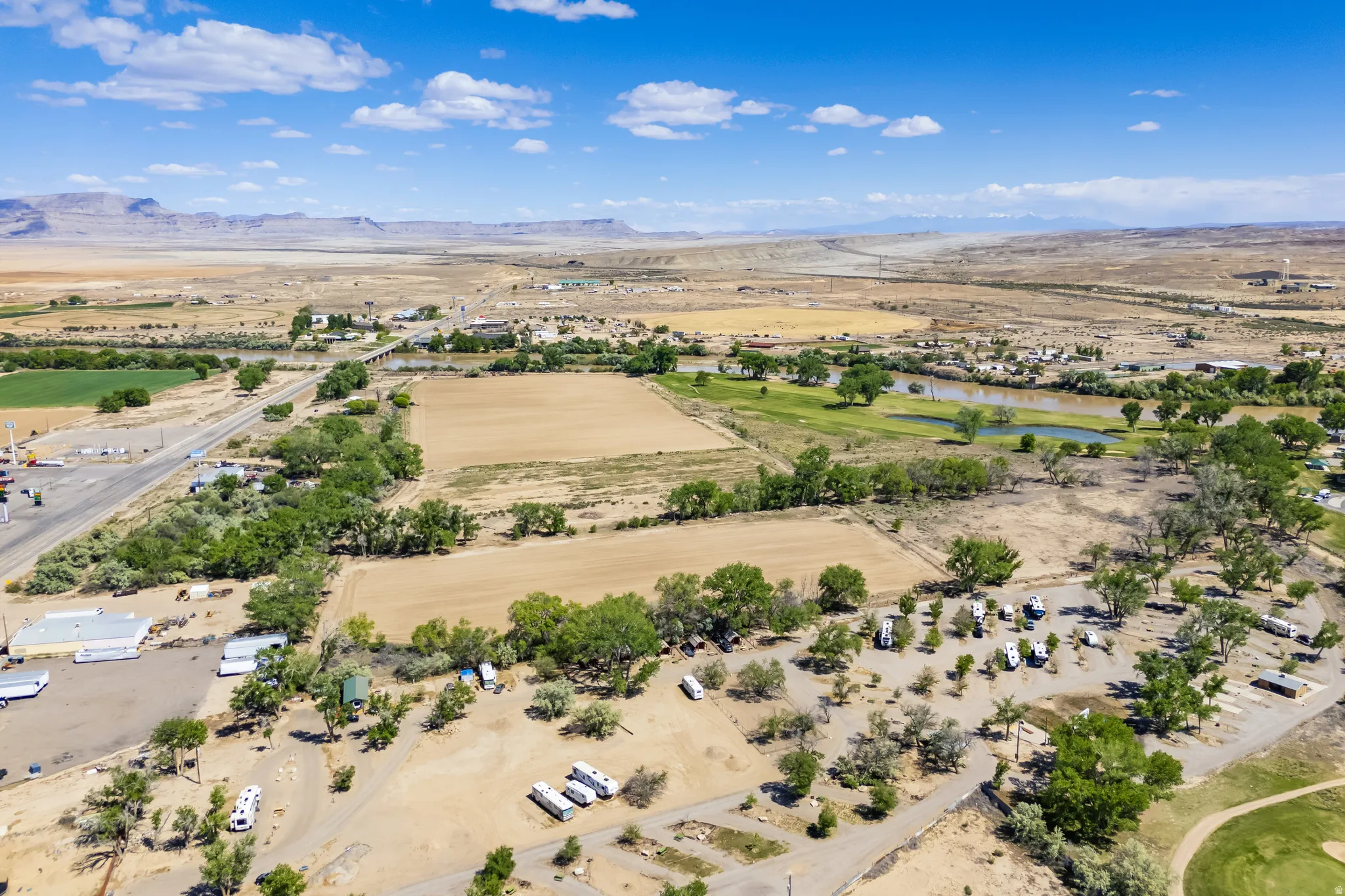 Expansive property featuring flat, undeveloped land, a river, and distant mountain ranges