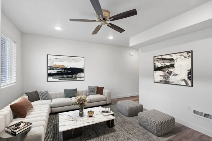 Recessed lighting and a ceiling fan illuminate this living space