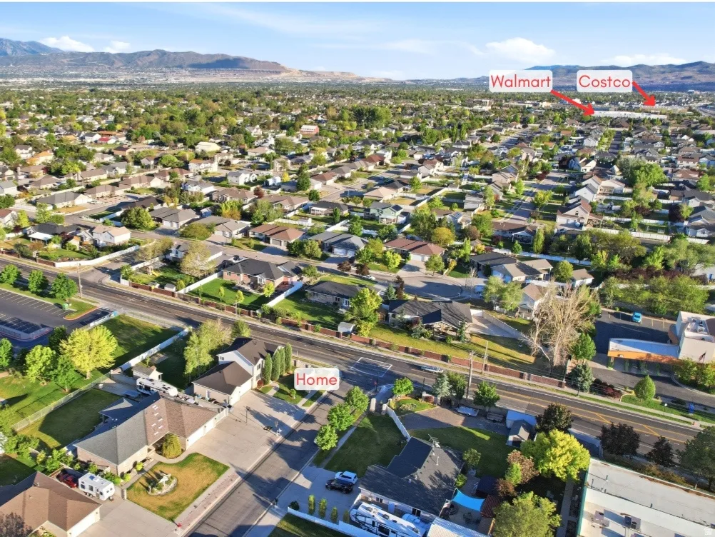Aerial perspective showcasing a residential neighborhood with a mountainous backdrop