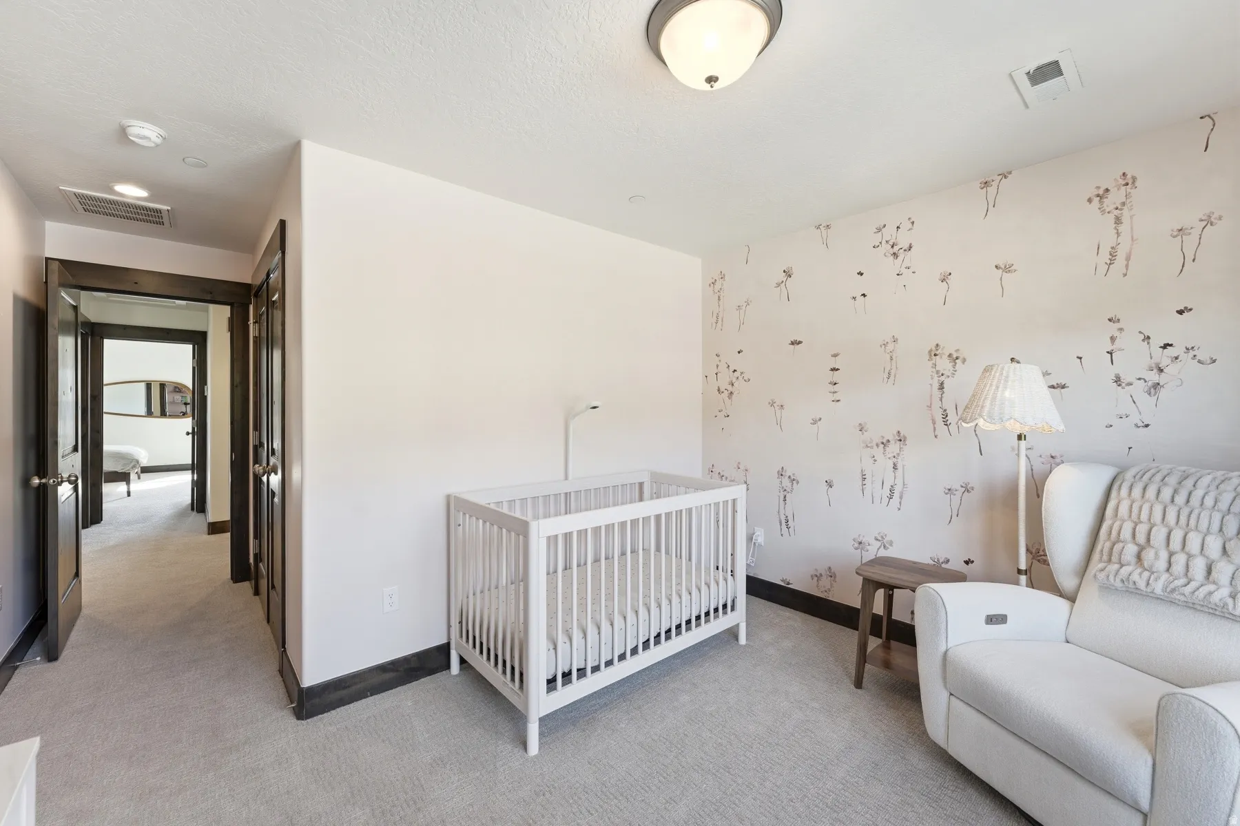 Bedroom featuring a decorative accent wall, recessed lighting, and light-toned carpeting